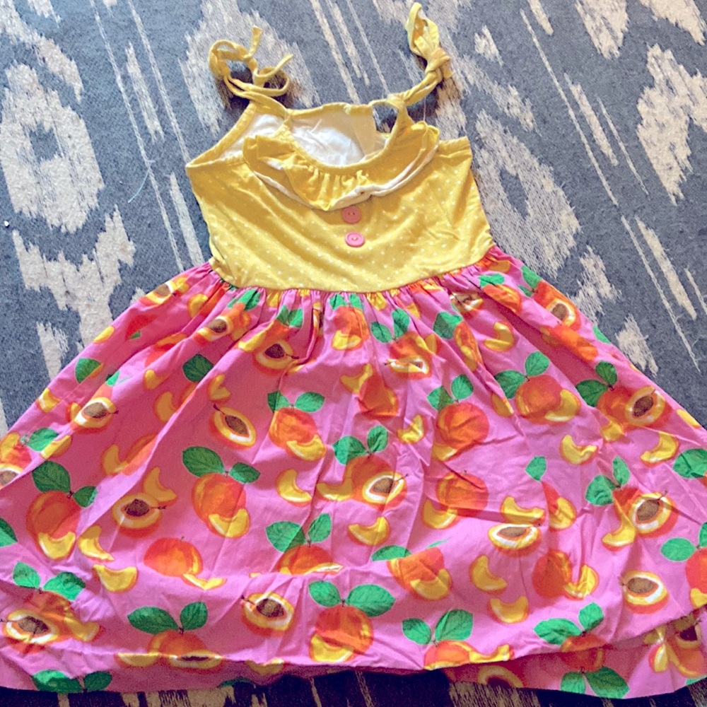 Eleanor rose peach sundress. Ruffle in front with tie straps.